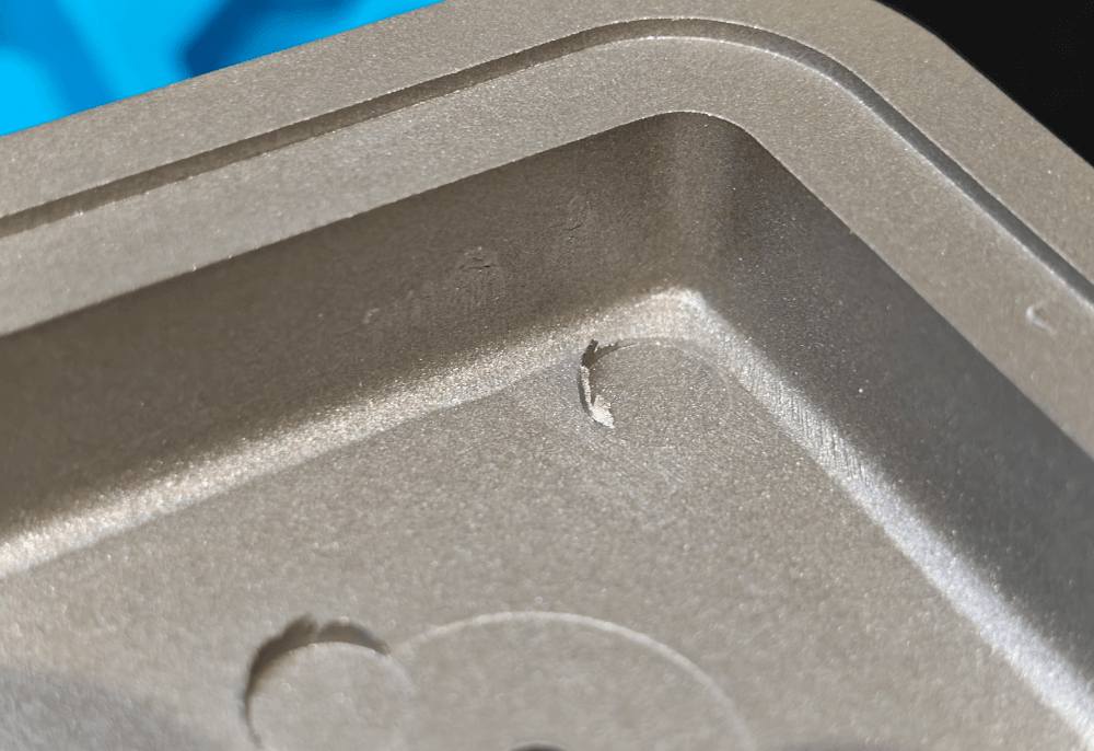 A close up of the inside of the case, showing the (rather poor) quality of the case manufacture. There are flakes of metal around some of the extrusion seams.