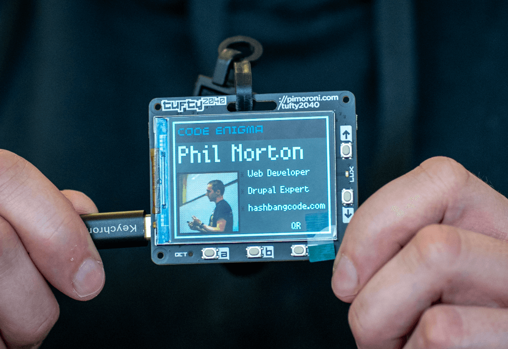 The tuftu2040 electronic badge, containing information about Phil Norton.