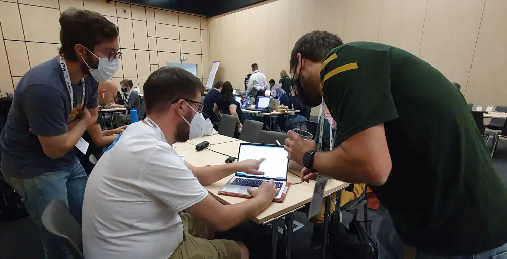 DrupalCon Prague 2022, showing a mentor helping a developer out with a git workflow question.