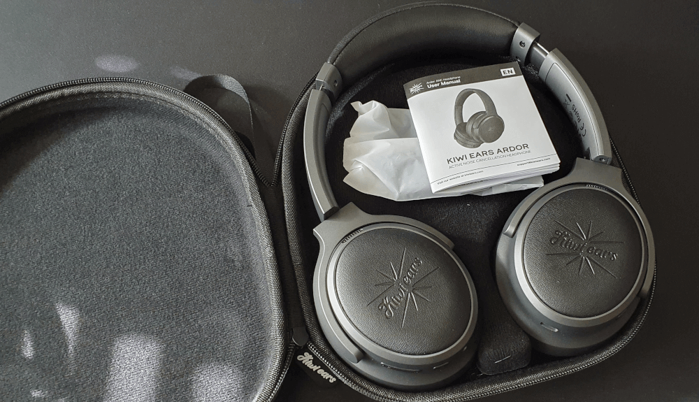 The inside of the Kiwi Ears Ardor headphones, showing the headphones, the instruction manual and the bags containing the included cables.