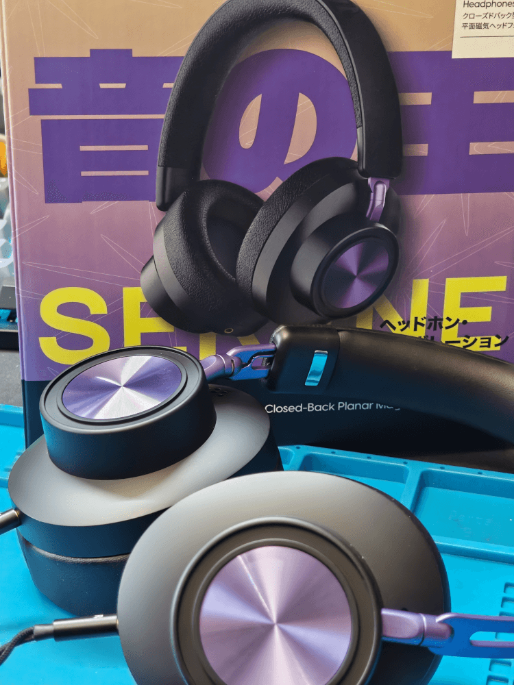 The Kiwi Ears x Z Reviews Serene in front of the box they came in.