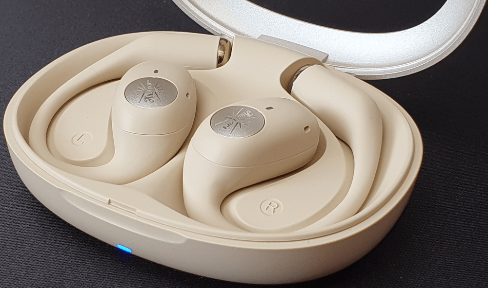 The Kiwi Ears Spark earphones, sat inside the case with the casse lid opened.