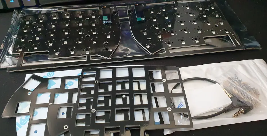 The un-assembled parts of a Lily58 keyboard.