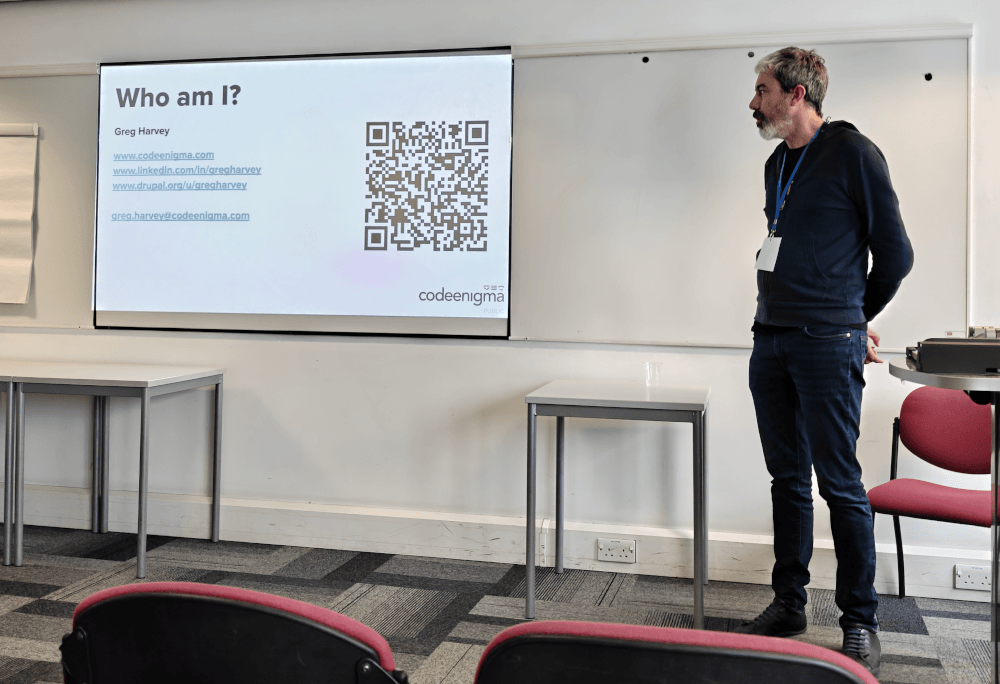 Greg Harvey, giving a talk about ethical AI. The current slide is about Greg himself.