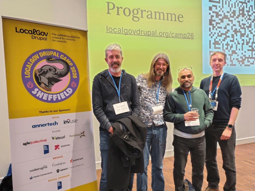Greg Harvey, Chris Maiden, Sunil Odera, and myself, stood in front of the LocalGov Drupal Camp 2026 signs.