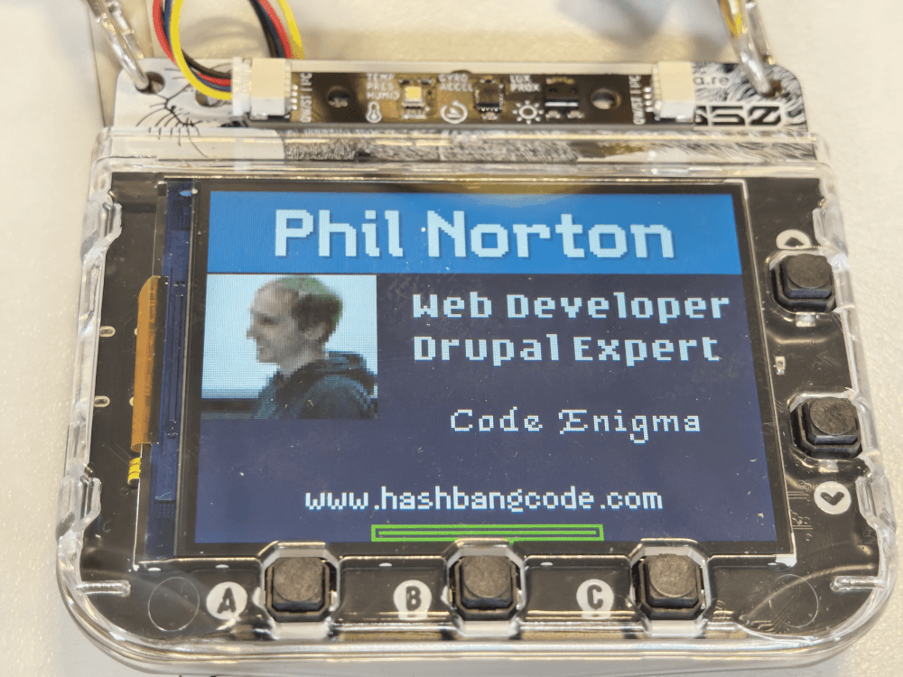 The finished Tufty2350 badge application. This shows Phil Norton in large letters, followed by web developer, Drupal expert, Code Enigma, www.hashbangcode.com